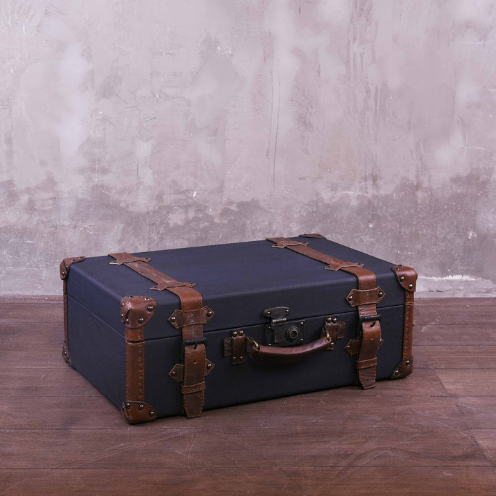 Vintage canvas and genuine leather side table suitcase trunk 1920s in close up details.