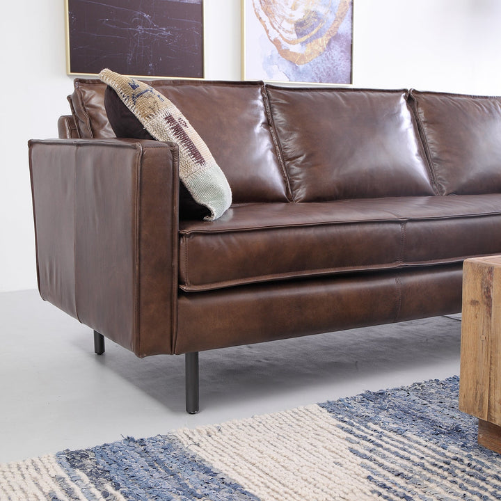 Vintage genuine leather 2 seater sofa belgian in close up details.
