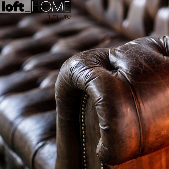 Vintage genuine leather 2 seater sofa chesterfield button in real life style.