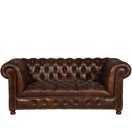 Vintage genuine leather 2 seater sofa chesterfield button in white background.