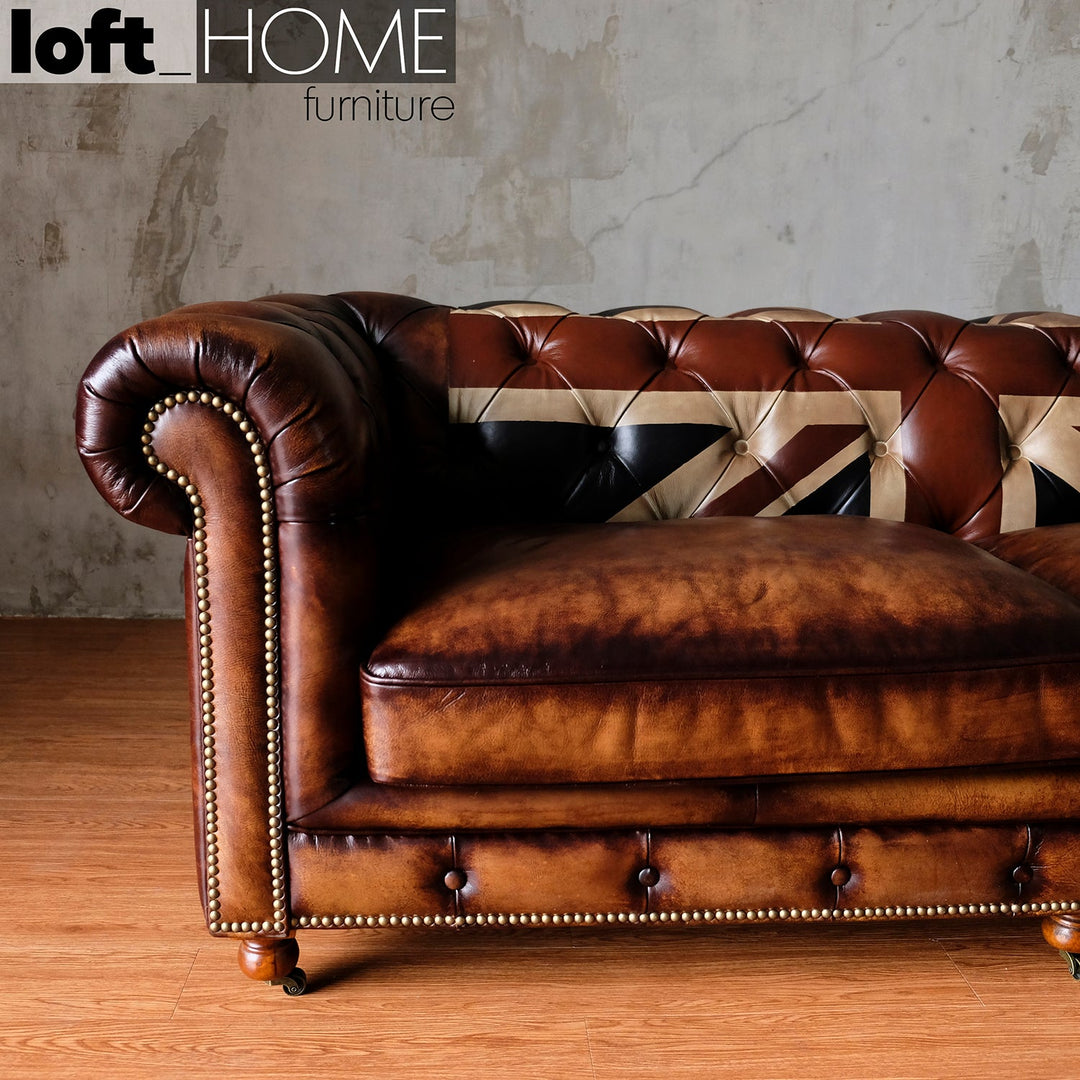 Vintage genuine leather 2 seater sofa chesterfield union jack in close up details.