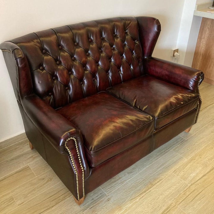 Vintage genuine leather 2 seater sofa franco in close up details.