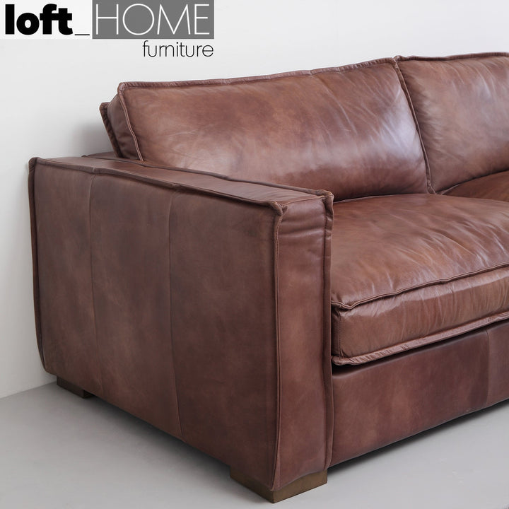 Vintage genuine leather 3 seater sofa brown whisky in close up details.