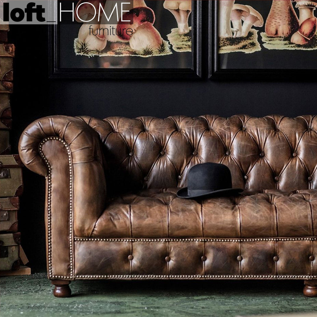 Vintage genuine leather 3 seater sofa chesterfield button with context.