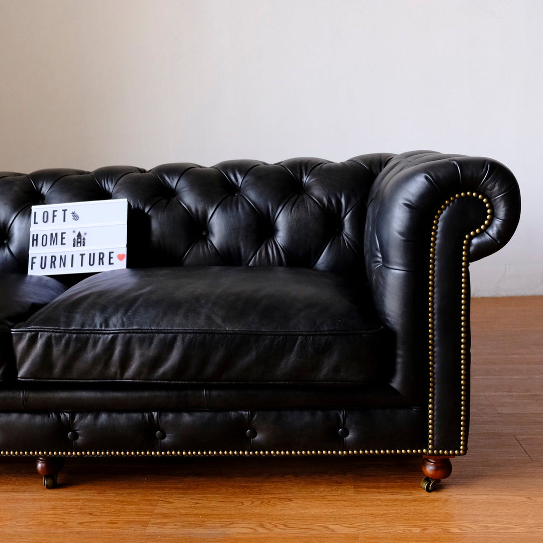 Vintage genuine leather 3 seater sofa chesterfield classic in close up details.