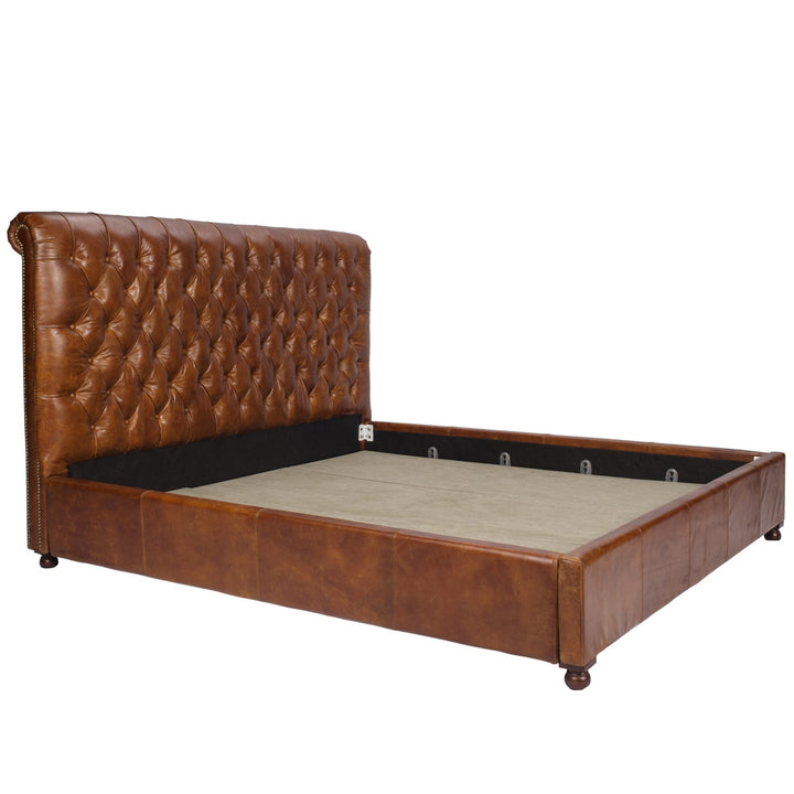 Vintage genuine leather bed frame chesterfield in white background.
