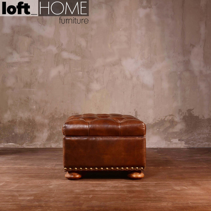 Vintage genuine leather ottoman chesterfield with context.