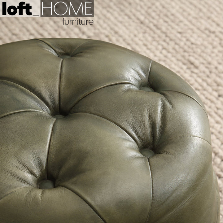 Vintage genuine leather ottoman green franco in close up details.