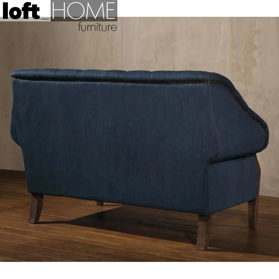 Vintage jeans fabric and genuine leather 2 seater sofa cowboy in close up details.