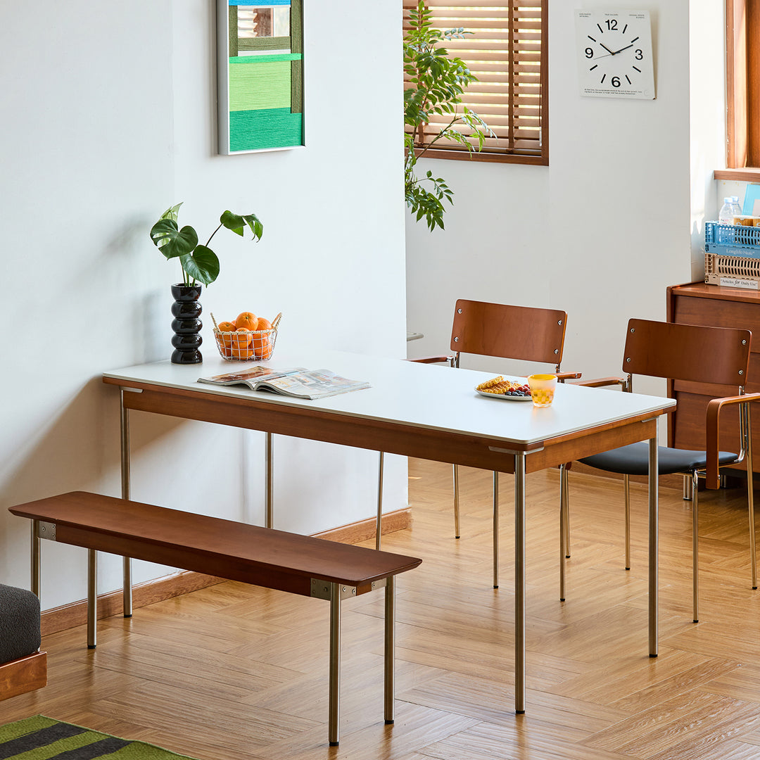 Vintage sintered stone boxwood dining table pinecone in still life.