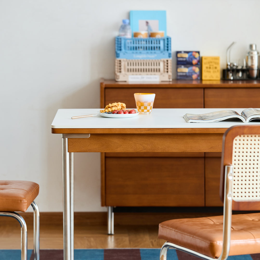 Vintage sintered stone boxwood dining table pinecone in panoramic view.
