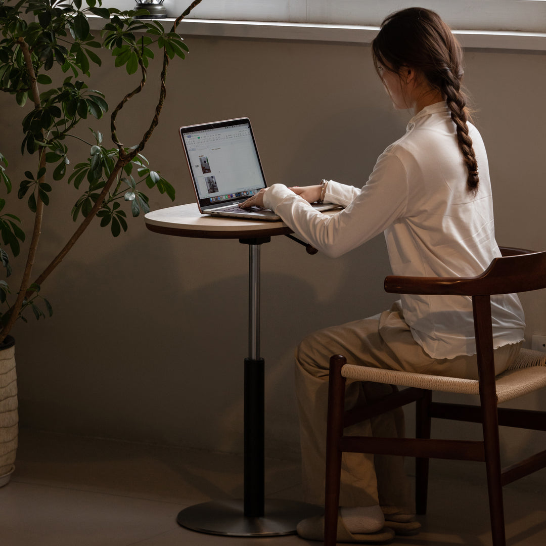 Vintage sintered stone height adjustable side table roman with context.
