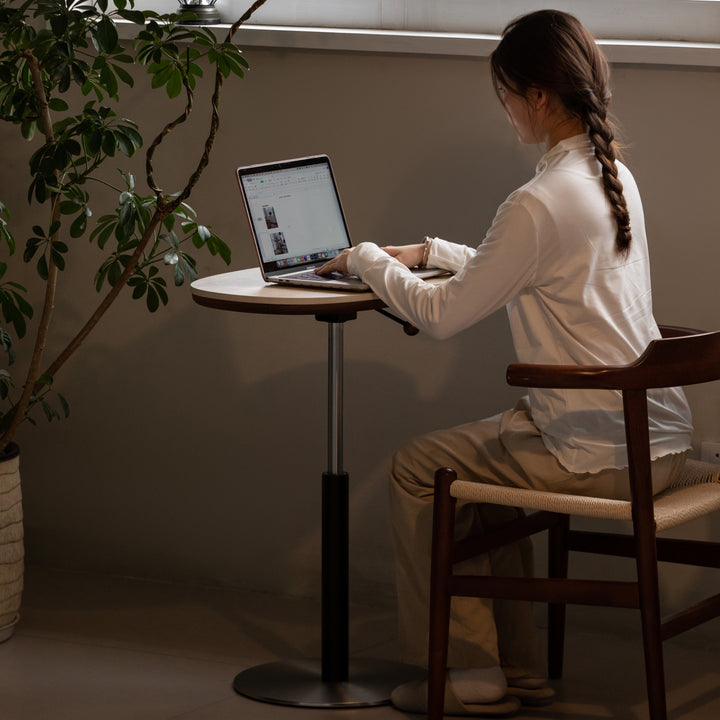 Vintage sintered stone height adjustable side table roman with context.