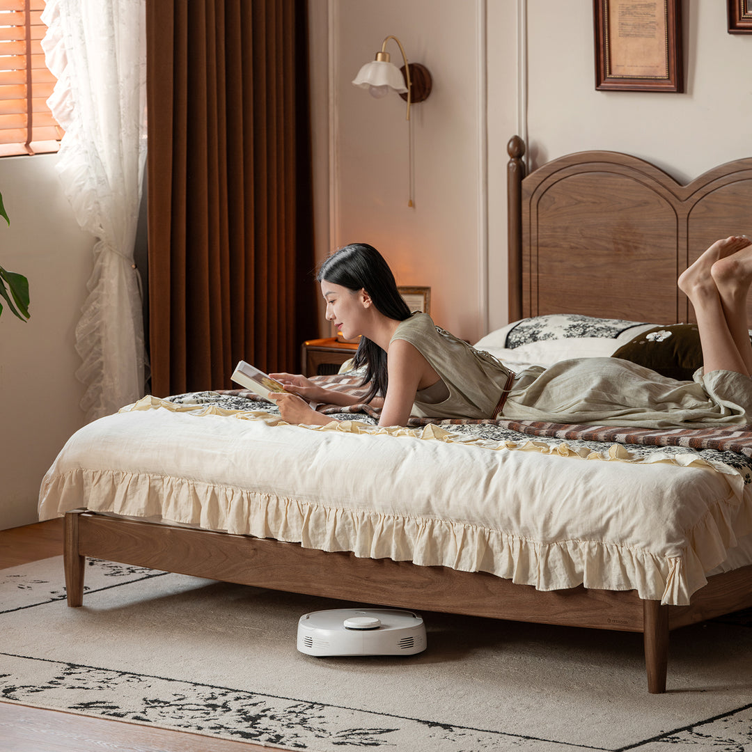 Vintage walnut wood bed midsummer in close up details.