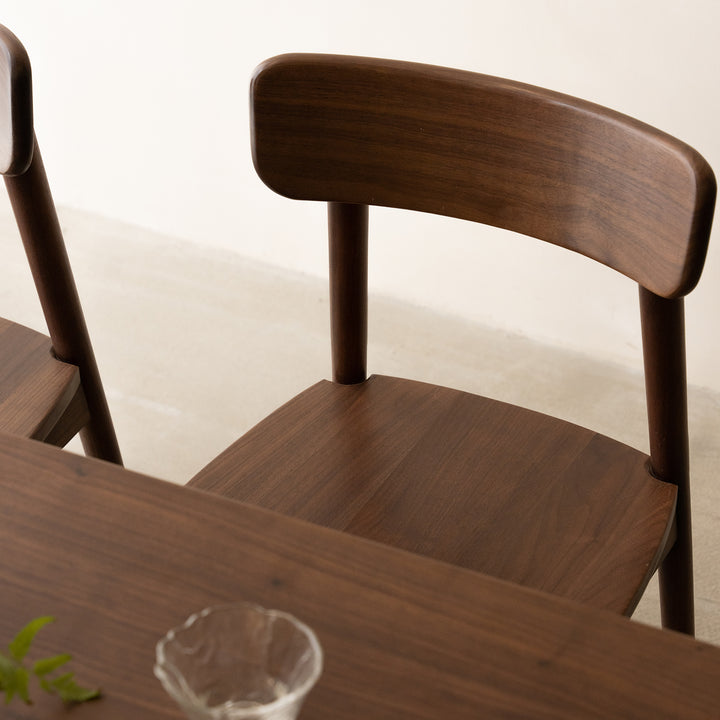 Vintage walnut wood dining chair green with context.