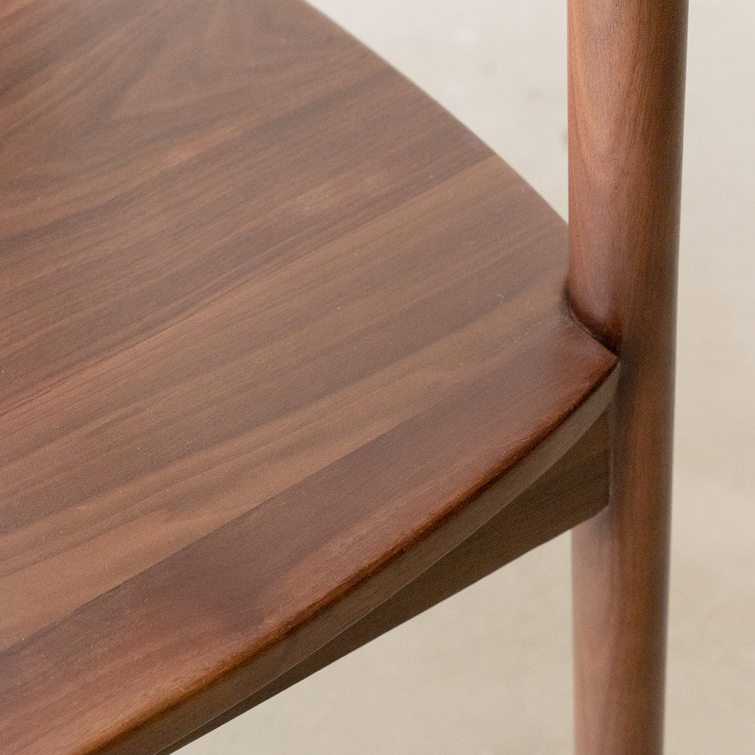 Vintage walnut wood dining chair green in close up details.
