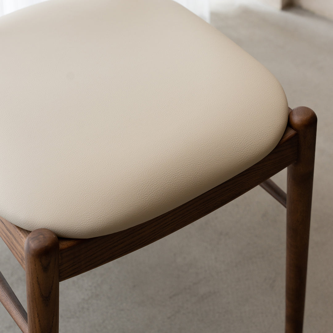 Vintage walnut wood dining chair purea in close up details.
