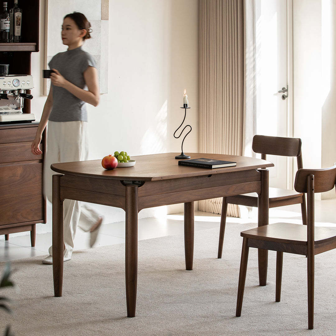 Vintage walnut wood extendable dining table minima in close up details.