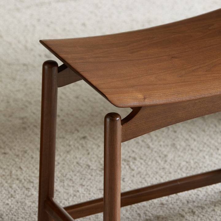 Vintage walnut wood stool arcus in real life style.